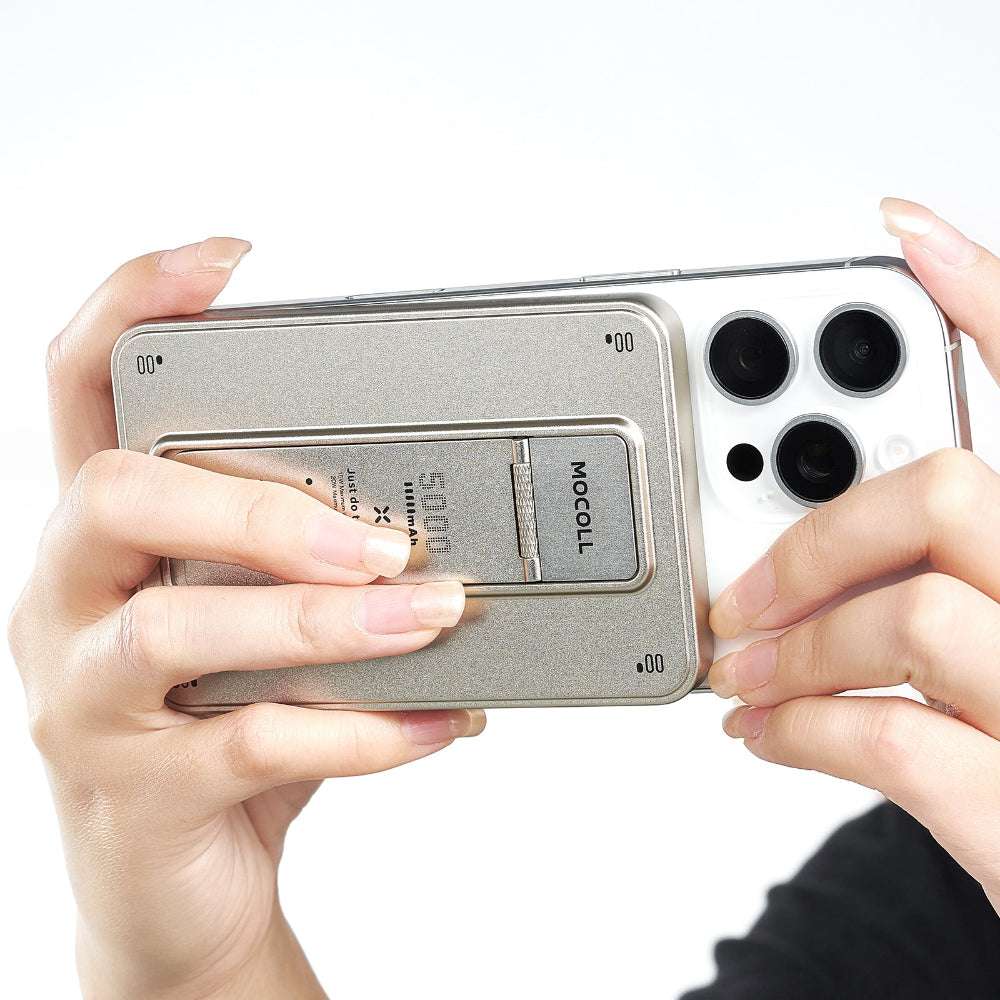 MOCOLL 20W portable power bank attached to the back of a smartphone held by two hands