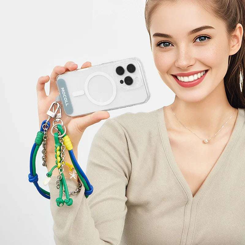 Smiling woman holding phone with colorful phone lanyard accessory by MOCOLL attached