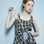 MOCOLL funny phone charm strap braided pink and white held by a woman wearing a plaid dress