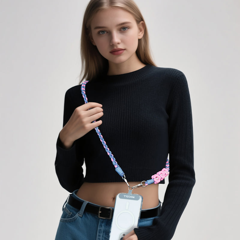 Woman wearing a colorful MOCOLL funny phone charm strap holding a phone with a clear case