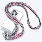 MOCOLL funny phone charm strap braided in gray and pink with decorative flowers attached to clear phone case