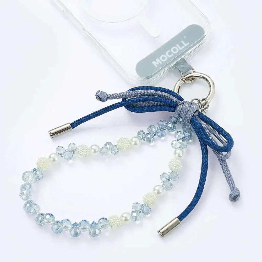 MOCOLL liquid ambar phone charm with blue beads and decorative bow attached to clear phone case